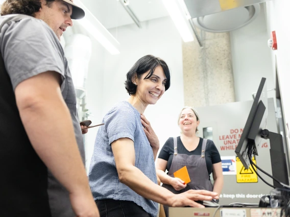 ADLI 2024 participants in the CATalyst Studio's laser cutter room.